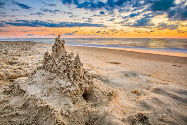 A drip sandcastle at sunrise on an Outer Banks beach.