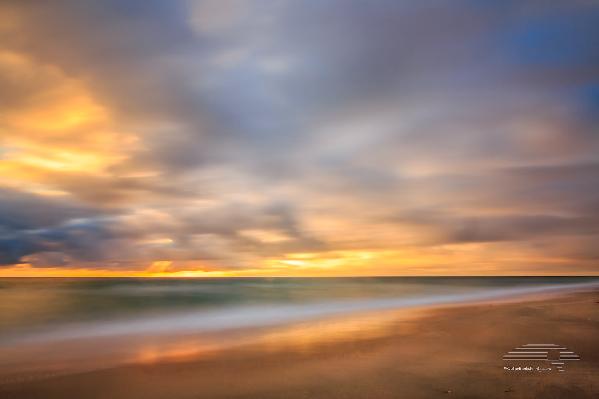 A one minute exposure of sunrise on a Kitty Hawk Beach on the Outer Banks, NC.