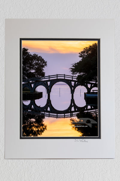 8 x 10 luster print in a 11 x 14 ivory and black double mat of A still sunset reflection of the wooden bridge between the Whale Head Club and Currituck Beach Lighthouse in Corolla on the Outer Banks of NC.