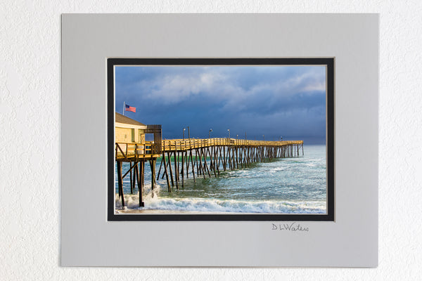 5 x 7 luster prints in a 8 x 10 ivory and black double mat of  Sunshine on Avalon Fishing Pier on a stormy afternoon at the Outer Banks of North Carolina.