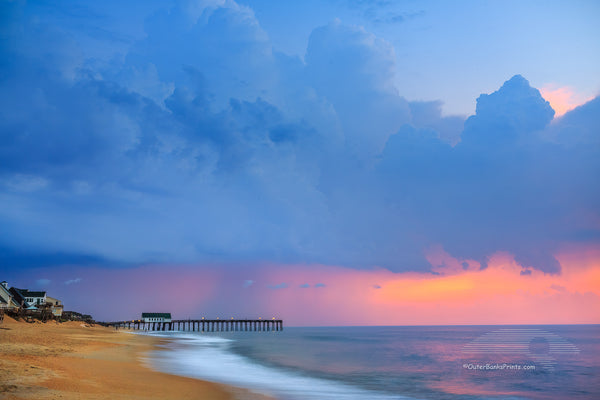 Storm clouds before sunrise above Kitty Hawk Pier on the Outer Banks of North Carolina.
