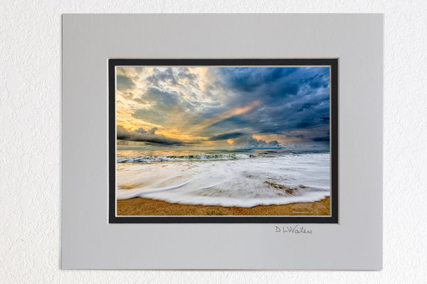 5 x 7 luster prints in a 8 x 10 ivory and black double mat of  Sunrise and clouds with light rays poking through stormy skies over Kill Devil Hills beach on the Outer Banks of NC.