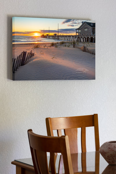 20"x30" x1.5" stretched canvas print hanging in the dining room of Early morning light stretches across the dunes at Jennette's Pier in Nags Head on the Outer Banks of North Carolina.