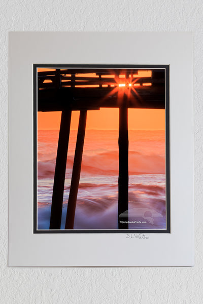 8 x 10 luster print in a 11 x 14 ivory and black double mat of Avalon fishing silhouetted against breaking waves at sunrise.