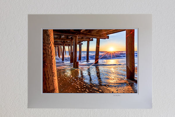 13 x 19 luster print in 18 x 24 ivory ￼￼mat of The sun peeking above horizon at Nags Head Fishing Pier Outer Banks, NC.