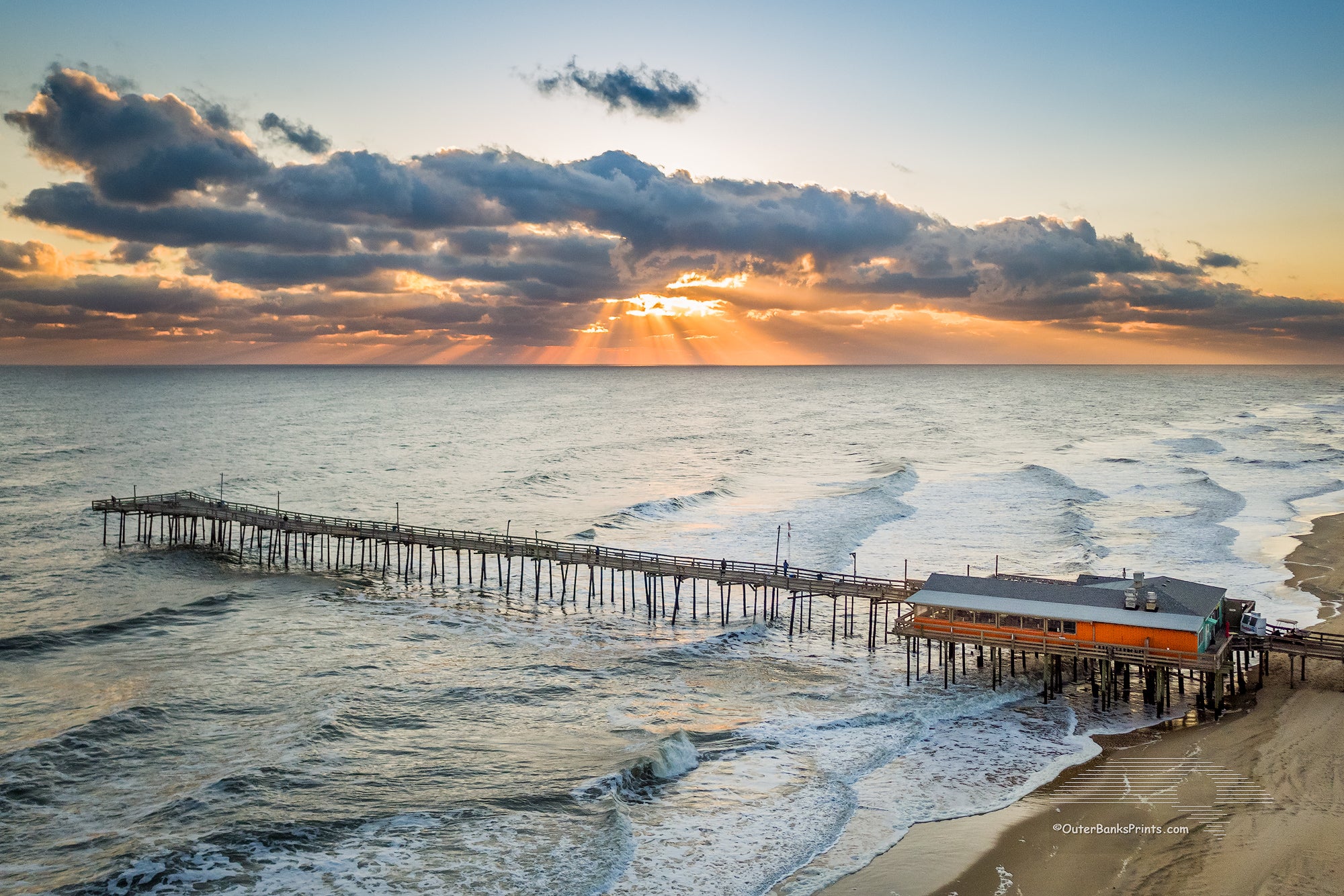 Aerial photo of the Outer Banks Fishing Pier at sunrise.