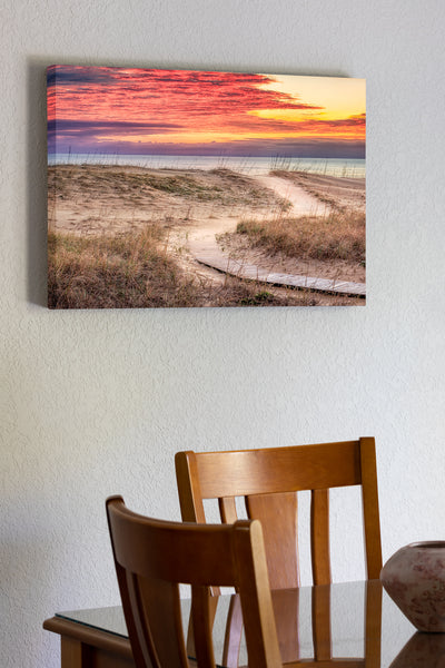 20"x30" x1.5" stretched canvas print hanging in the dining room of Clouds at sunris with a curvy path leading to a Kitty Hawk Beach on the Outer Banks of NC.