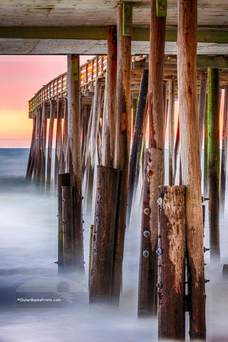 Long exposure turns the surf into mist under Kitty Hawk Pier at sunrise.