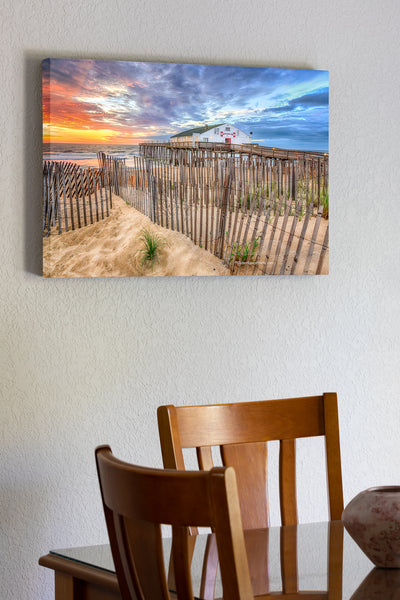 20"x30" x1.5" stretched canvas print hanging in the dining room of Sand fence at sunrise in front of Kitty Hawk Fishing Pier on the Outer Banks.