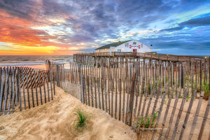 Sand fence at sunrise in front of Kitty Hawk Fishing Pier  on the Outer Banks.