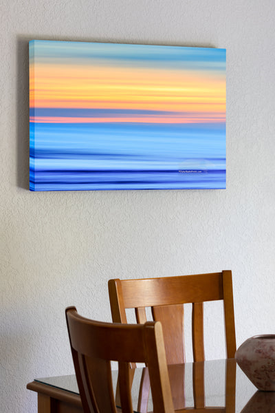 20"x30" x1.5" stretched canvas print hanging in the dining room of A Outer Banks beach sunrise reduced to colors and lines. Using camera movement during a long exposure to blur the beach and ocean.