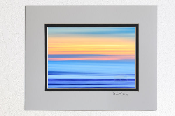 5 x 7 luster prints in a 8 x 10 ivory and black double mat of  A Outer Banks beach sunrise reduced to colors and lines. Using camera movement during a long exposure to blur the beach and ocean.