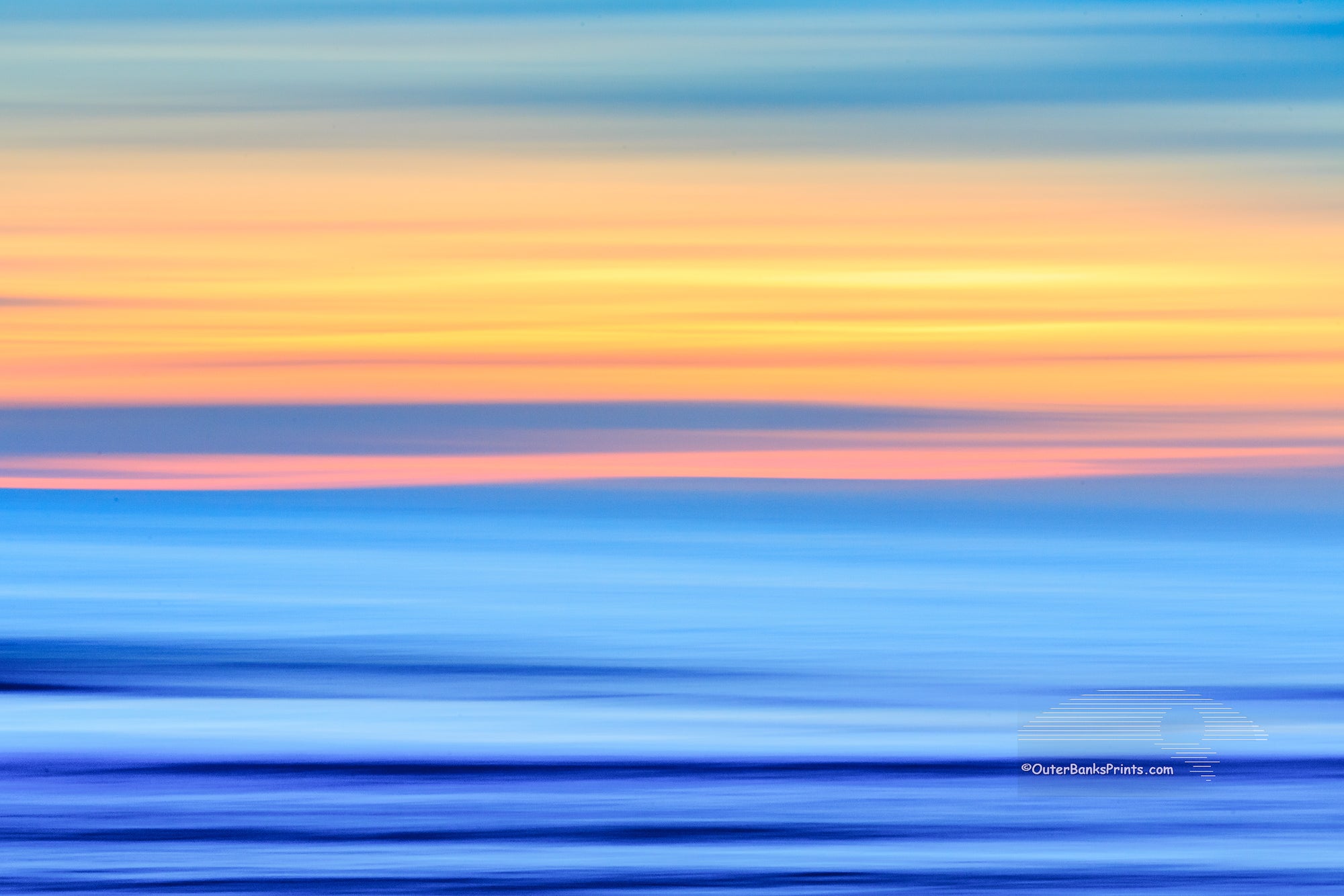 A Outer Banks beach sunrise reduced to colors and lines. Using camera movement during a long exposure to blur the beach and ocean.