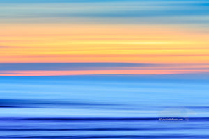 A Outer Banks beach sunrise reduced to colors and lines. Using camera movement during a long exposure to blur the beach and ocean.