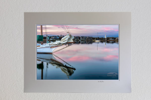 13 x 19 luster print in 18 x 24 ivory ￼￼mat of Sail boat and reflection at twilight on Silver Lake Ocracoke Island, Outer Banks, NC.