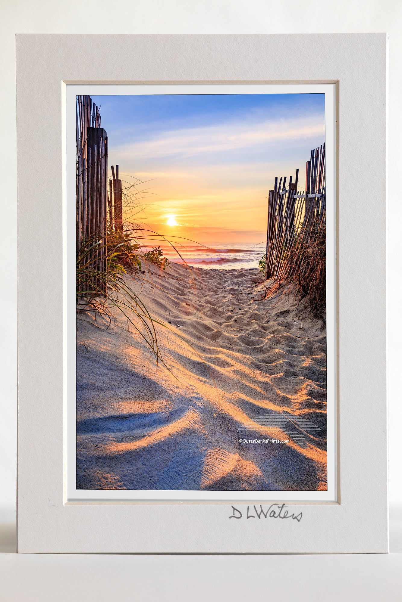 4 x 6 luster print in a 5 x 7 ivory mat of  Kitty Hawk beach access at sunrise on the Outer Banks, NC. It's interesting how the sunlight plays across the foot prints in the sand.