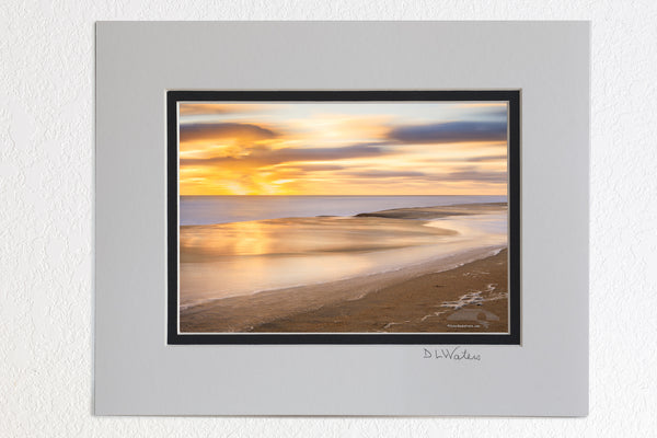 5 x 7 luster prints in a 8 x 10 ivory and black double mat of  Long sunrise exposure at Kitty Hawk beach reflecting in the surf on the Outer Banks of NC.