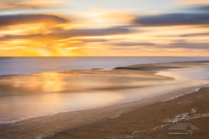 Long sunrise exposure at Kitty Hawk beach reflecting in the surf on the Outer Banks of NC.