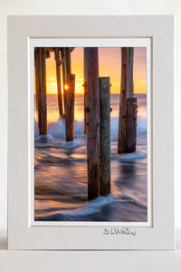4 x 6 luster print in a 5 x 7 ivory mat of Long exposure of the surf and a sun star under Avalon Fishing Pier in Kill Devil Hills on the Outer Banks.