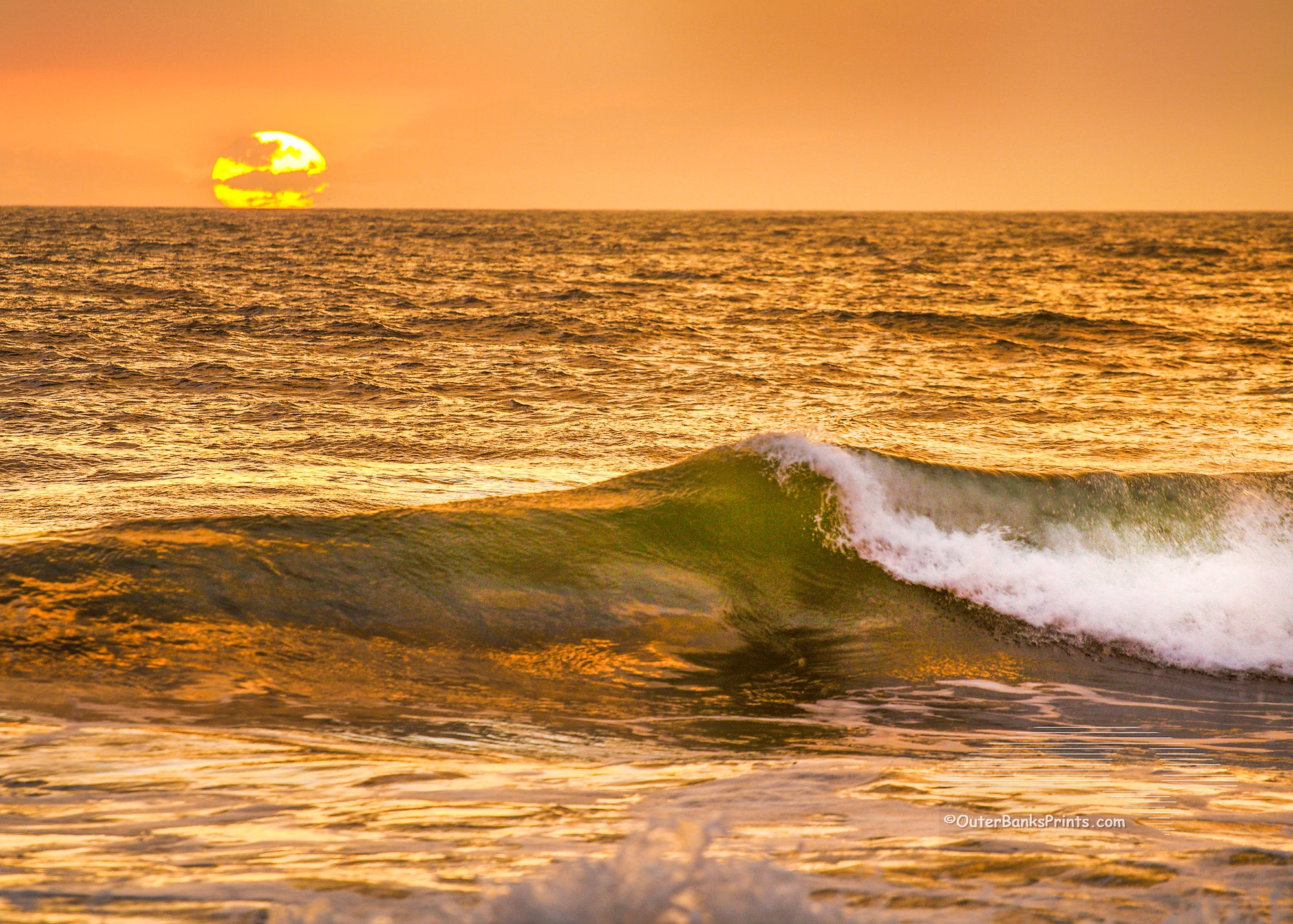 Picture of a golden sunrise at a Outer Banks beach.