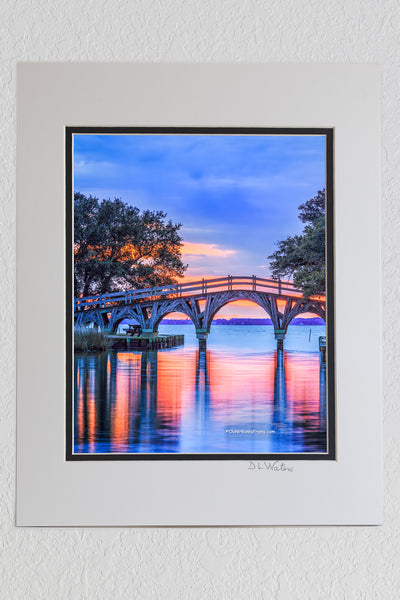 8 x 10 luster print in a 11 x 14 ivory and black double mat of Twilight reflection of the wooden bridge that connects the Whale Head Club to Currituck Beach Lighthouse.