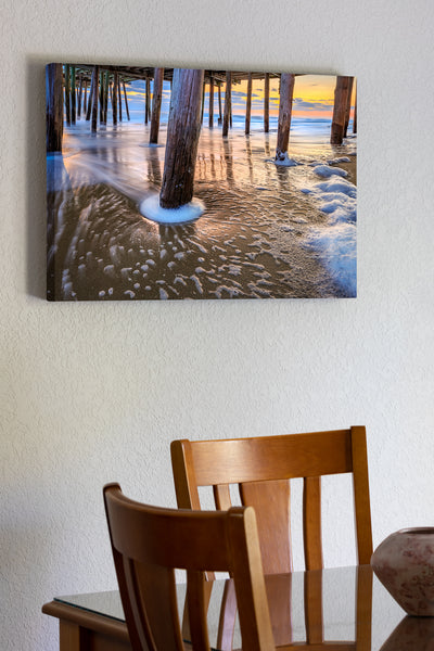 20"x30" x1.5" stretched canvas print hanging in the dining room of Surf washing around the Kitty Hawk Pier pilings on the Outer Banks of North Carolina.