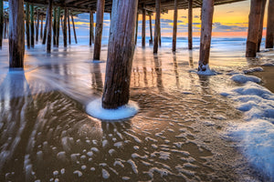 Surf washing around the Kitty Hawk Pier pilings on the Outer Banks of North Carolina.