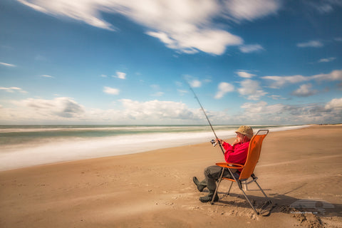 Long exposure showing movement of the clouds and the surf of a fisherman waiting for a bite on their Core Banks of NC.