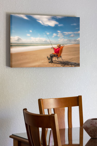 20"x30" x1.5" stretched canvas print hanging in the dining room of Long exposure showing movement of the clouds and the surf of a fisherman waiting for a bite on their Core Banks of NC.