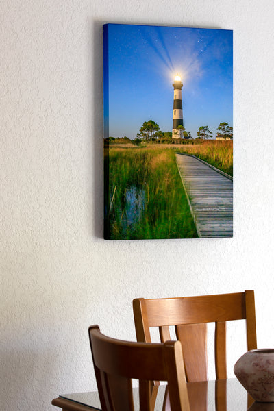 20"x30" x1.5" stretched canvas print hanging in the dining room of Bodie Island Lighthouse and boardwalk through marsh at night on Hatteras Island National Seashore.