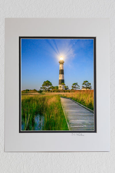 8 x 10 luster print in a 11 x 14 ivory and black double mat of Bodie Island Lighthouse and boardwalk through marsh at night on Hatteras Island National Seashore.