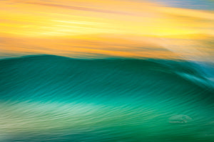 Impression of a wave at sunrise, using a long exposure to show movement on the outer Banks of NC.