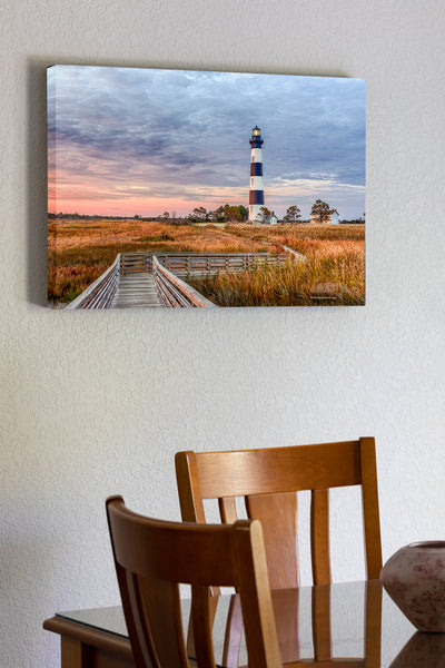 20"x30" x1.5" stretched canvas print hanging in the dining room of A walkway through the marsh leading to Bodie Island Lighthouse at sunrise.